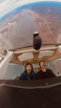 Jp Valery and an instructor flying upside down above a river